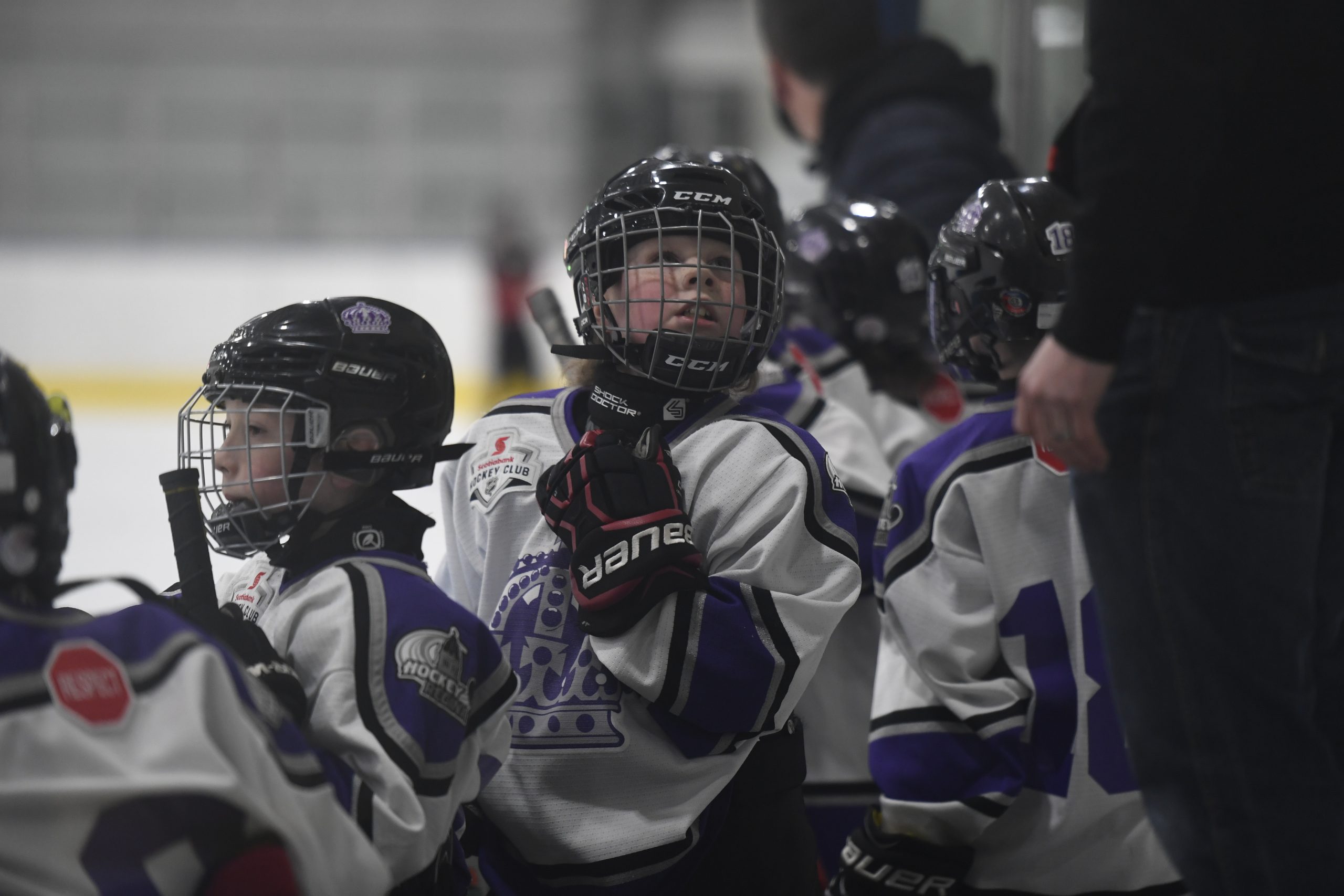 Youth hockey team in helmets on ice