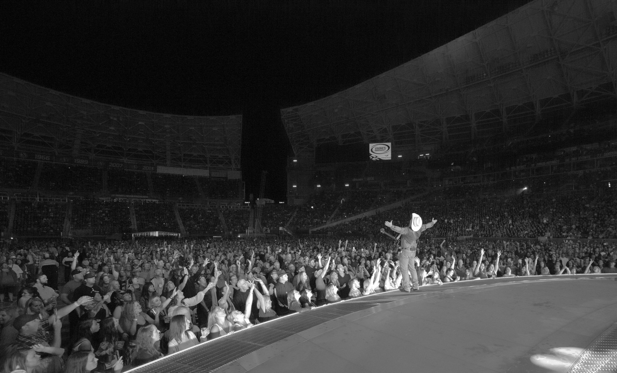 Performer on stage at packed outdoor concert