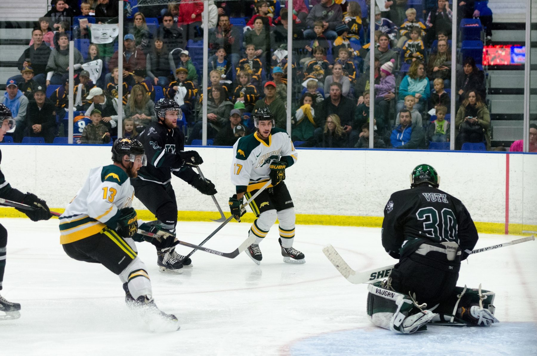 Ice hockey players during intense game action.