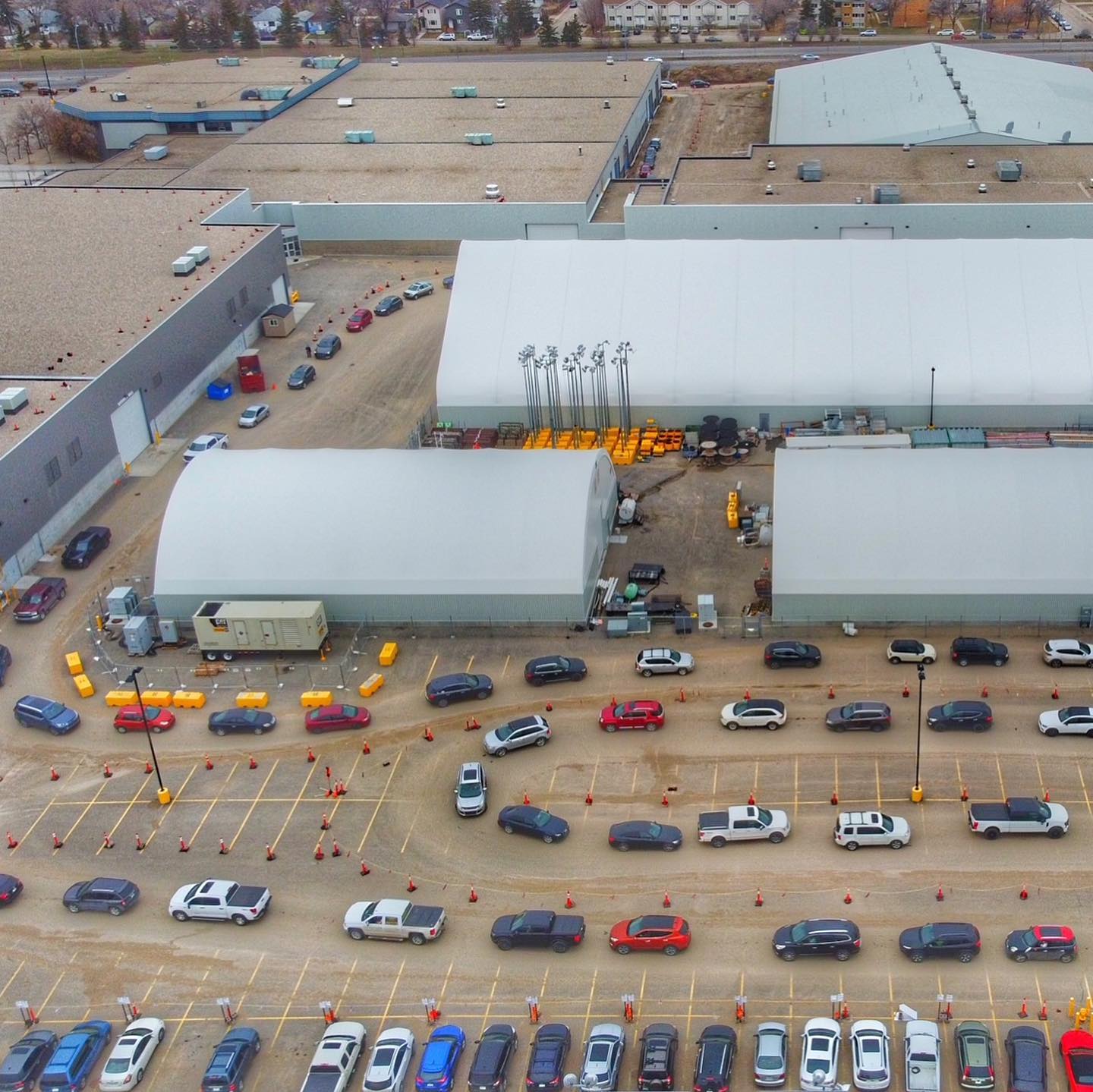 Aerial view of cars in parking lot near buildings.